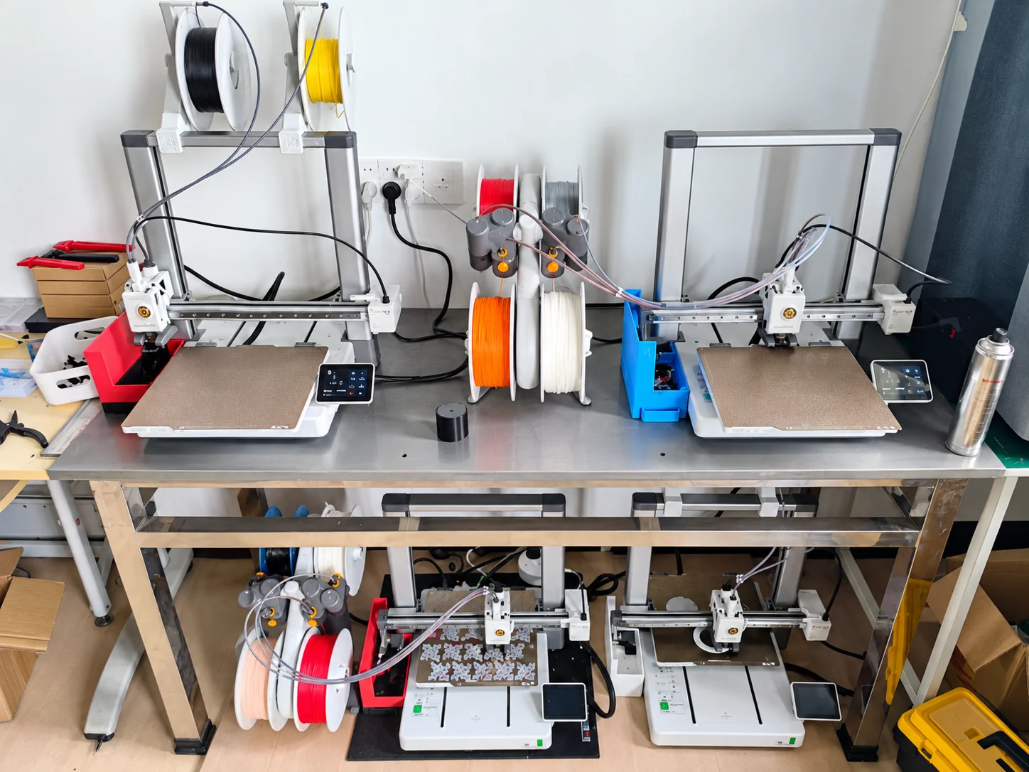 Workshop shelves with multiple 3D printers and filament storage