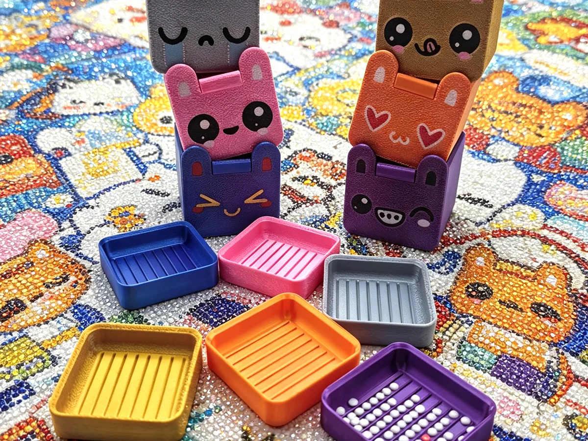 Collection of animal-themed 3D-printed box lids with matching grooved trays