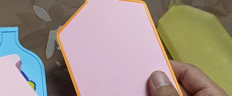 Hand holding a 3D-printed bottle-shaped case